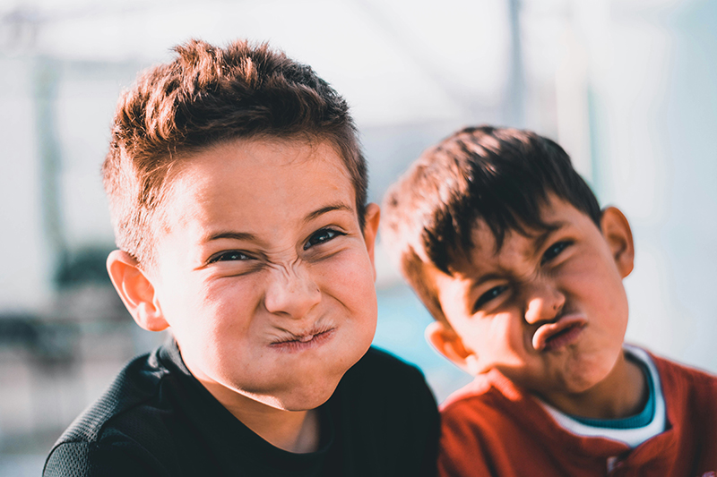 Close up of two children making faces at the camera.