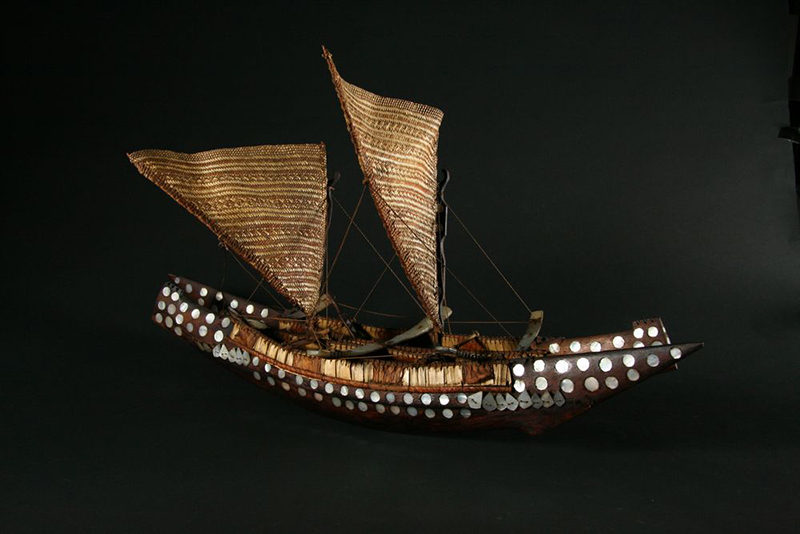 A model of a Cook Islands sailing vessel with inlaid mother-of-pearl and woven sails.