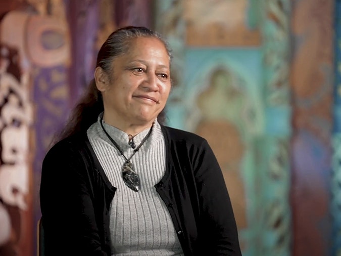 Still from interview with Moana Parata. Te Papa The head and shoulders of a woman smiling gently at someone off camera.