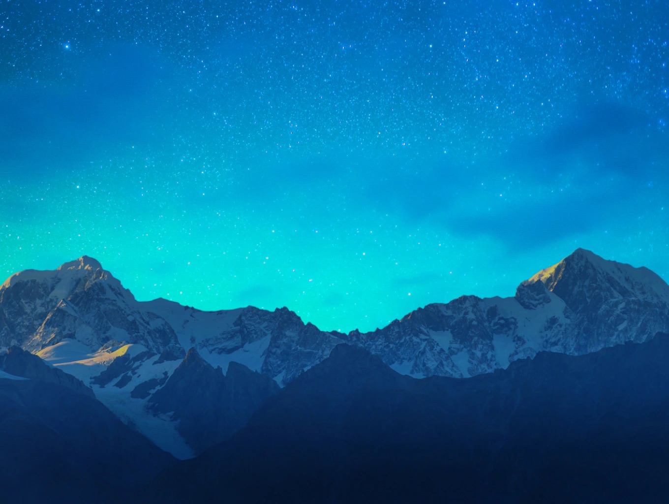 A view of snowy mountains at night.