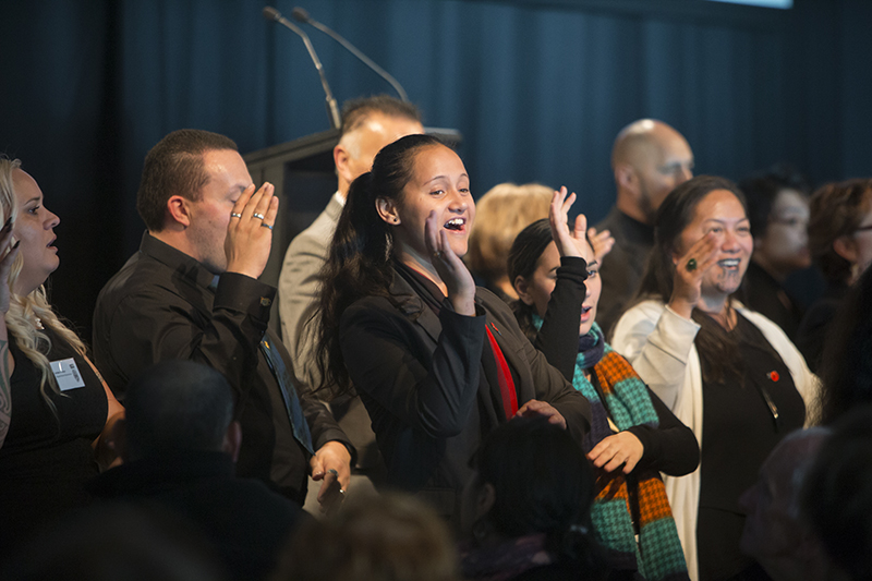 Several people performing a song with hand actions.