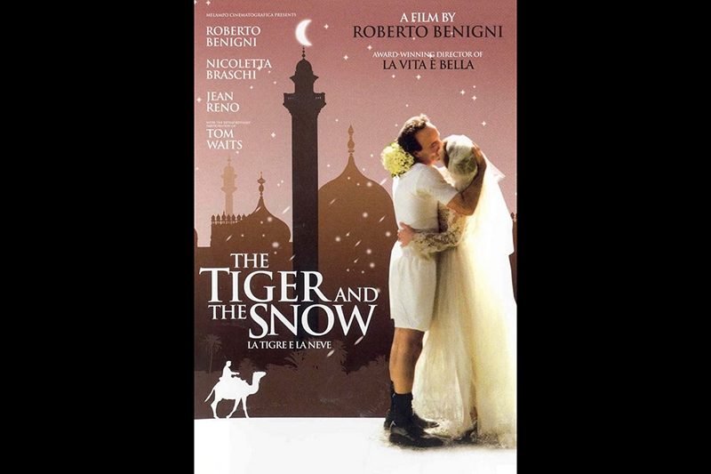 A poster with the title in English and in Italian (La tigre e la neve) depicting a couple kissing, actors names, and a silhouette of someone riding a camel.