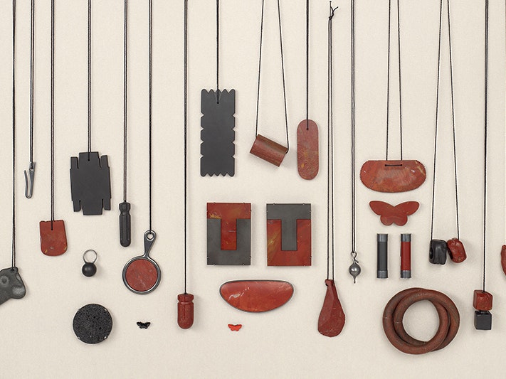 Warwick Freeman, A different red, a different black, 1999-2013; New Zealand. Purchased 2013. Te Papa (2013-0015-1/1-27 to 27-27) A spread of different pieces of jewellery made by the same jeweller. Most of them are hanging on dark threads.
