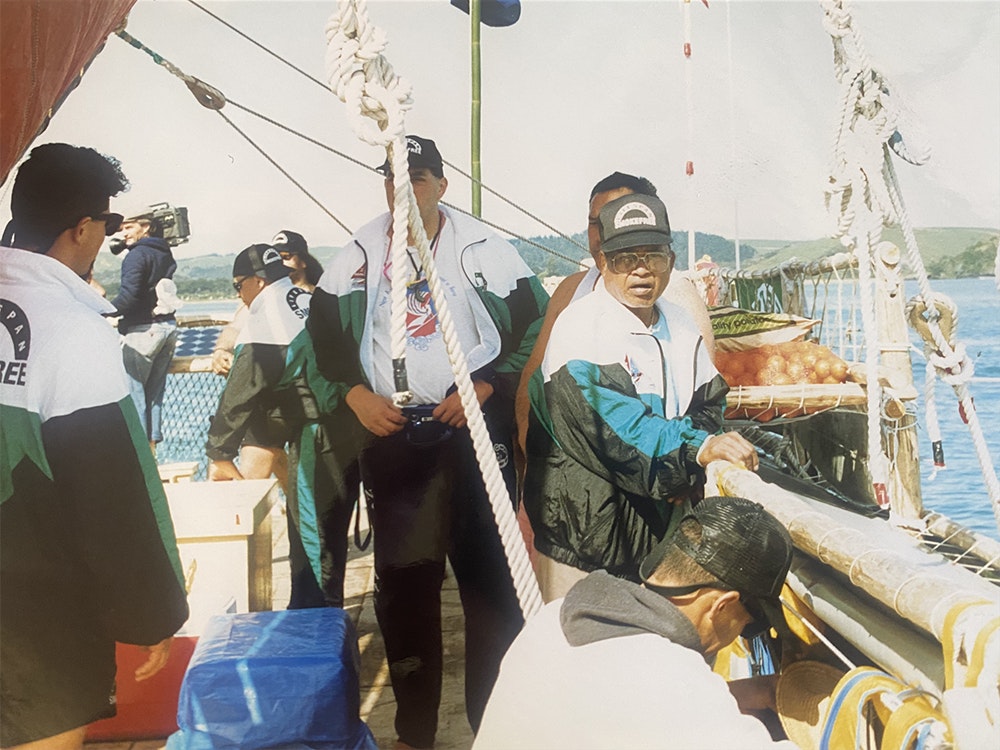 Mau Piailug (facing camera) and crew aboard Te Aurere , 1992. Courtesy of Te Kura Waka Voyaging Society A photo of several crew members on a boat.