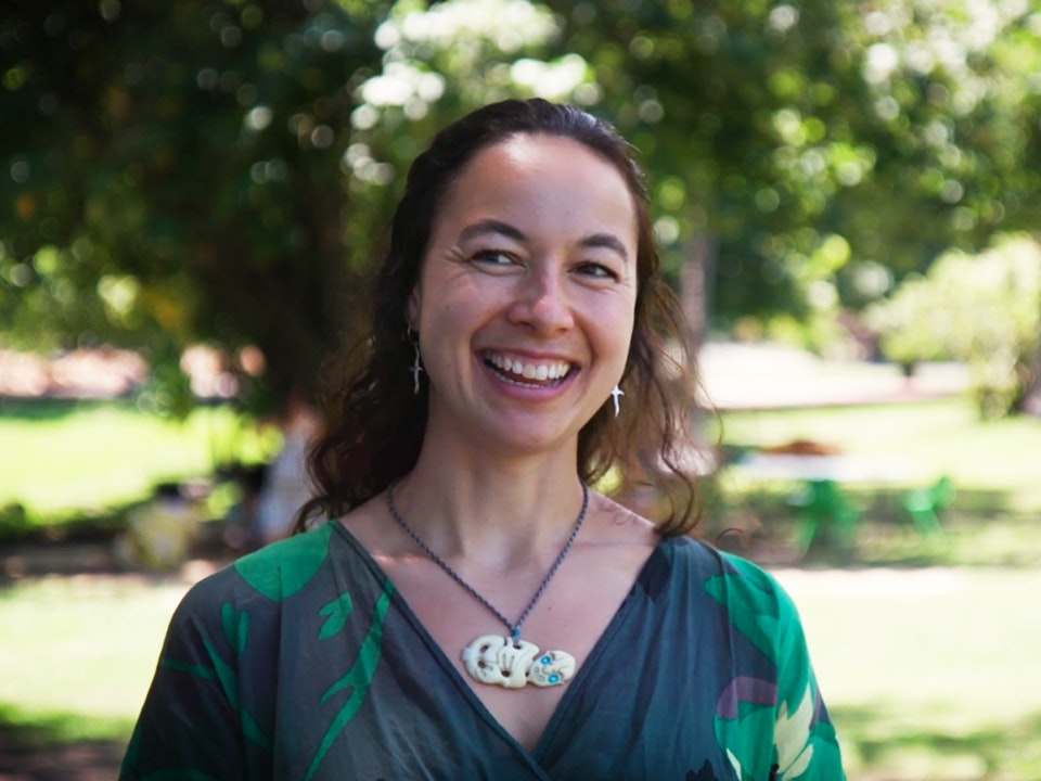 Still from video with Nikau Hindin. Te Papa Still from a video of a woman talking and smiling. She is looking just off camera.