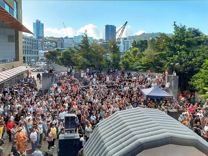 Rongo Rēhutai, Red Gates. Photo by Gioia Damosso. Te Papa (243015) A large crowd in front of an inflatable stage outside.