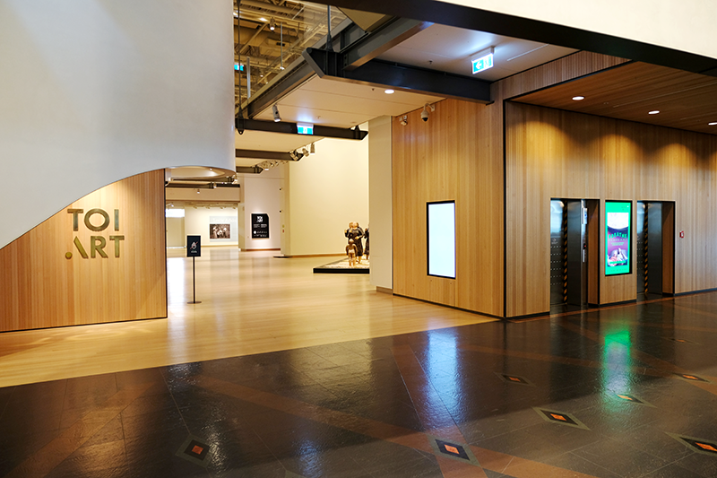 Level 4 gallery entrance, 2025. Photo by Rowan Moulder. Te Papa Gallery entrance, with artworks visible and lifts on right.