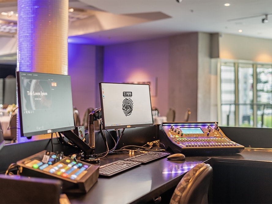 Te Papa Venues, 2024. Photo by The Way Home. Te Papa (274174) A desk with a computer screen and keyboard and several audio and lighting mixing desks.