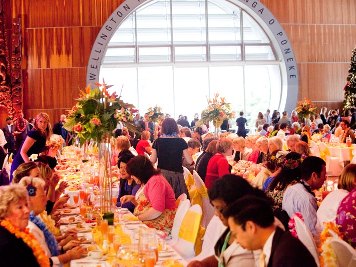 Dinner in Wellington Foyer, 2011, photo by Michael Hall. Te Papa (84157) A large gathering is seated at tables set for a wedding.