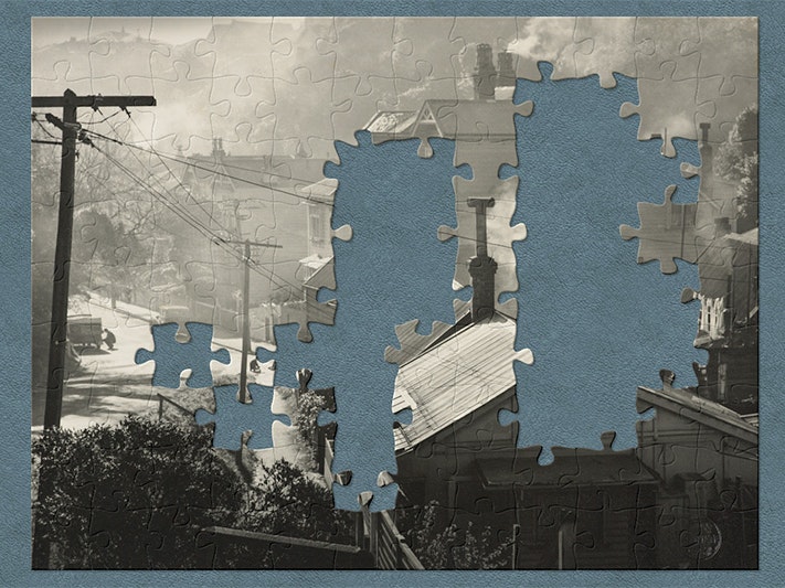 Jigsaw George Ward, Sydney Street West, Wellington, about 1957. Purchased 2009. Te Papa (O.031830) A black and white photograph on a teal background with jigsaw shapes missing.