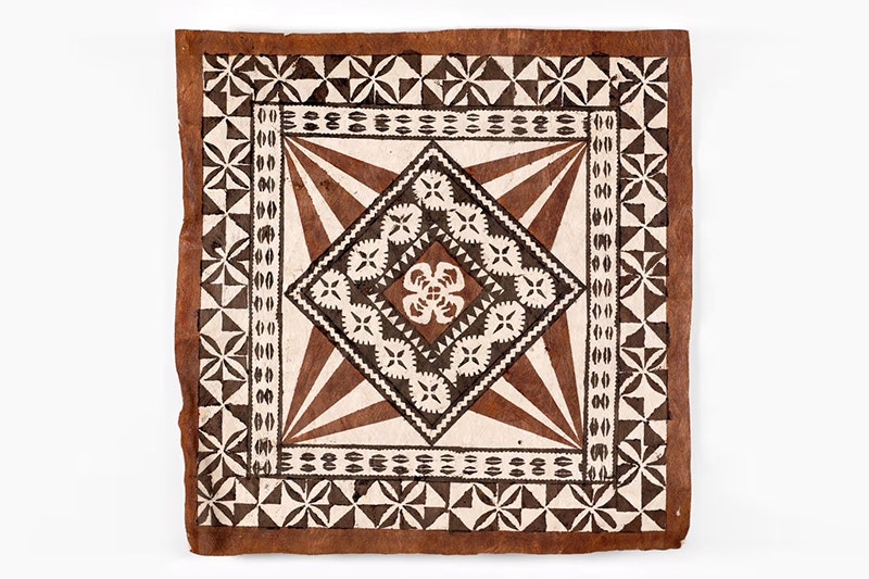 Masi (tapa cloth) titled "Let it shine", by Liviana Qaranivalu, 2023, Tahiti. Commissioned 2023. Te Papa (FE013729) A square tapa cloth with brown and black geometrical patterns painted on it.