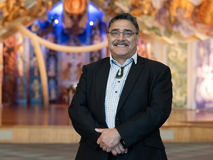 Kaihautū and Acting Tumu Whakarae Arapata Hakiwai, 2021. Photo by Daniel Rose. Te Papa (174685) A man are standing in the contemporary marae at Te Papa